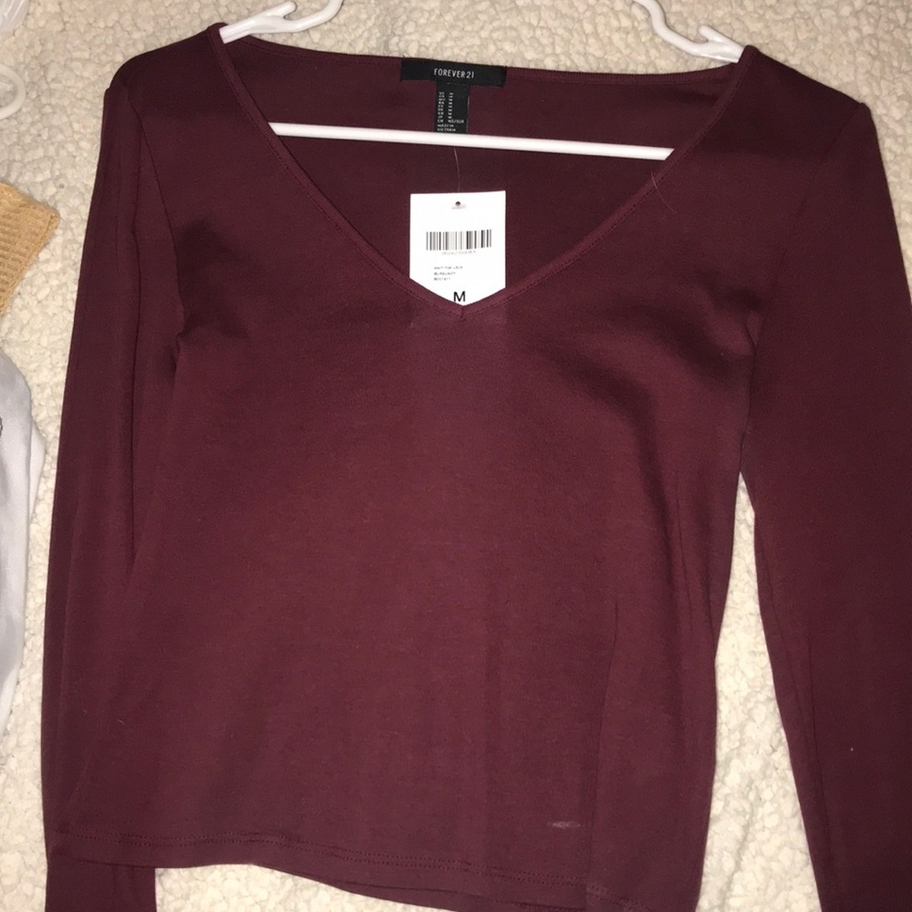 A maroon v neck long sleeve t shirt